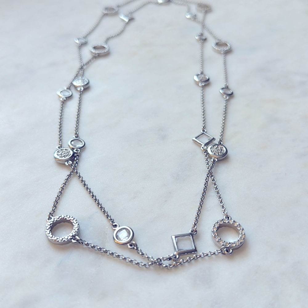 Gorgeous silver-colored necklace with rhinestone pave embellished gems.